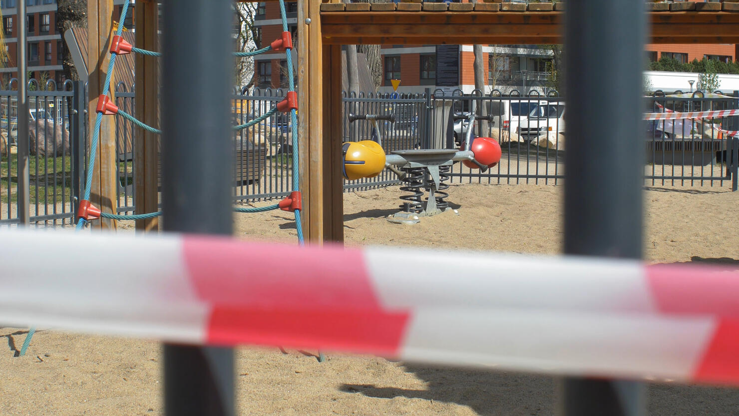 Caution Tape on Empty Playground Closed due to Coronavirus Epidemic Quarantine