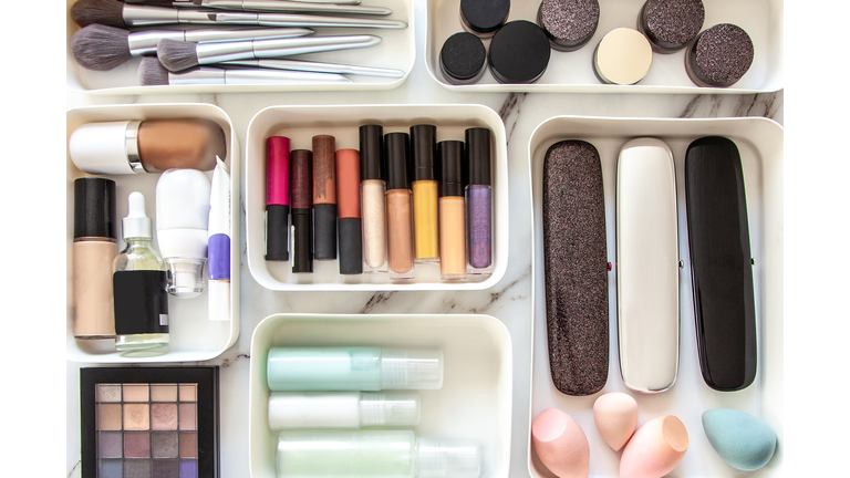 Woman hands neatly placing cosmetic and vanity items in MUJI's PP makeup storage boxes