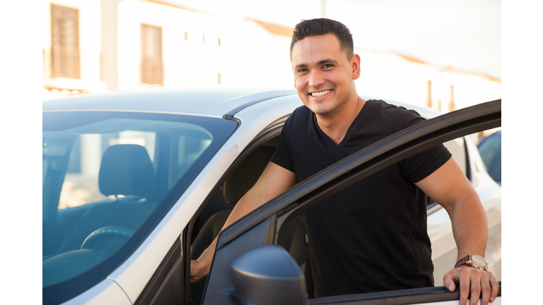 Handsome man getting into his car