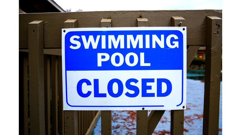 Swimming Pool Closed Sign on Safety Fence