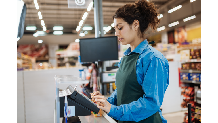 Female Latina employee in supermarket