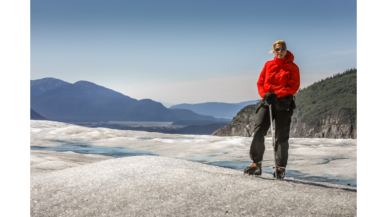 Full Length Of Senior Woman Standing On Snowy Mountain Against Sky