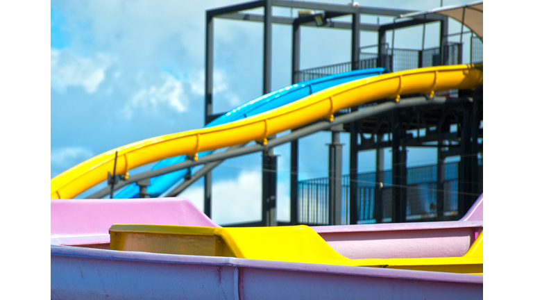 Colorful plastic water-slides in amusement park.