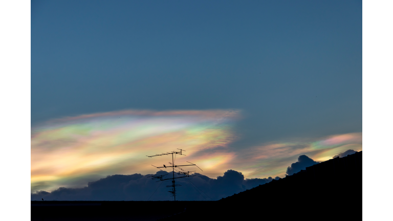 Beautiful iridescent cloud, Irisation. Skyscraper background.