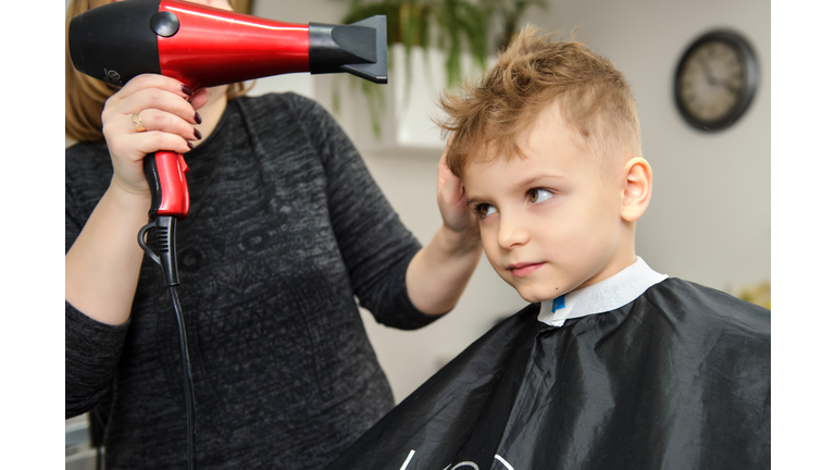 Close up picture of boy/child kid, sitting in the hairdressing salon