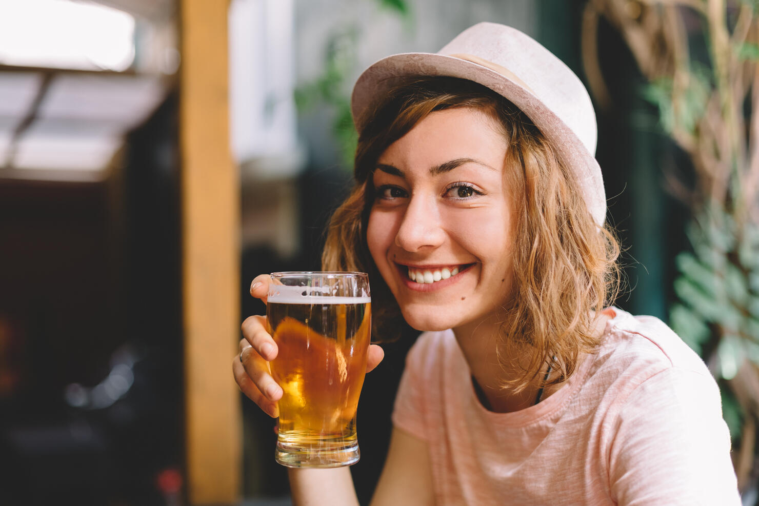 Smiling woman holding a pint of beer