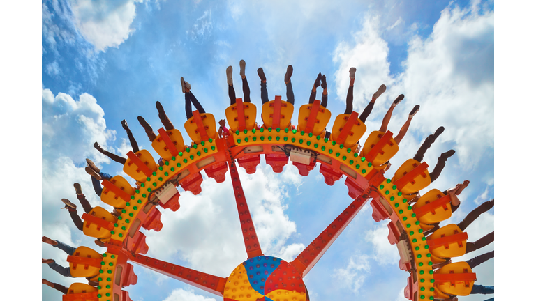 People riding with fun on extreme attraction in amusement park