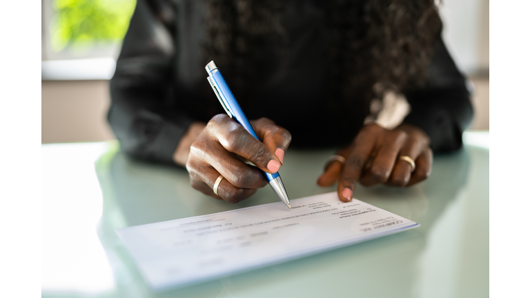 African Woman Writing Check