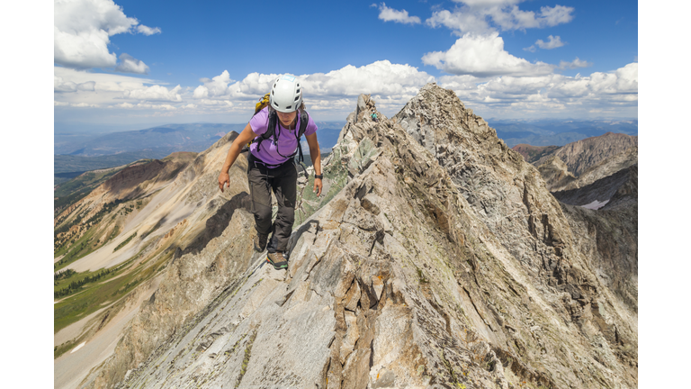 Women climb narrow ridge on Capitol Peak, Elk Mountains, Colorado