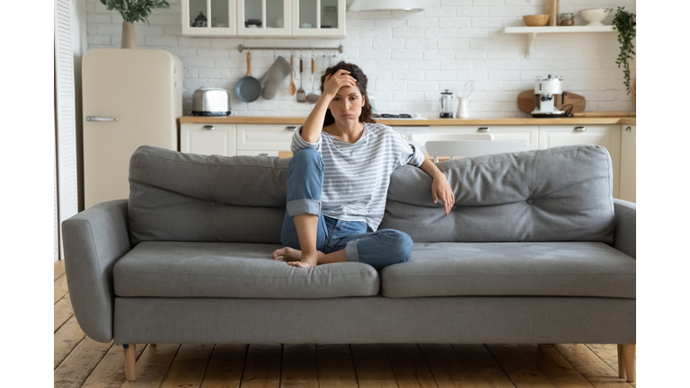 Tired upset woman worried about tiredness from domestic work.