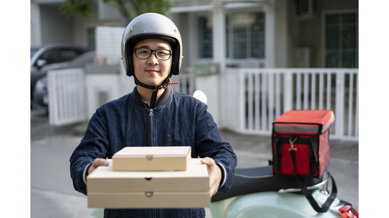 Delivery boy bringing pizza