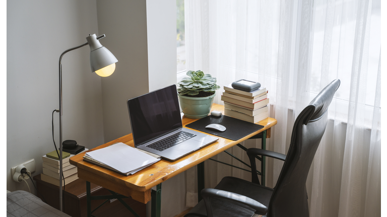 Simple home office setup with a table and laptop