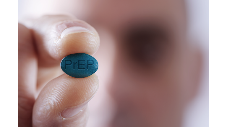 young man with a PrEP pill