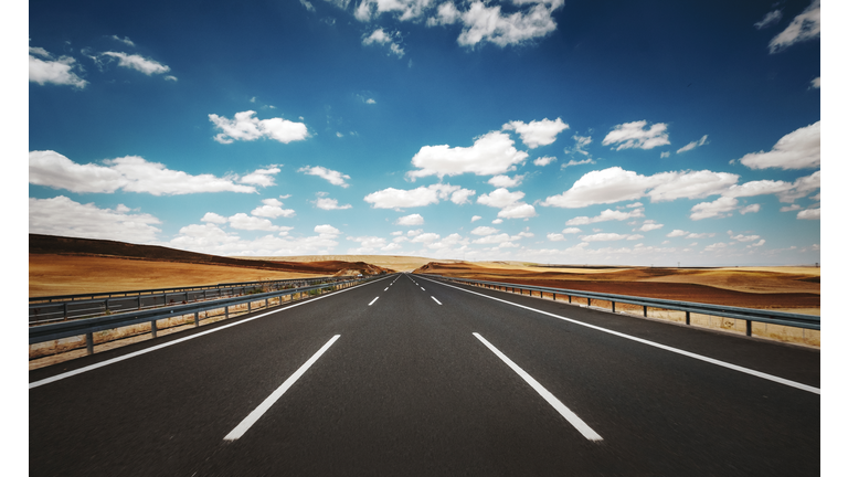 Empty highway road in a cloudy summer day