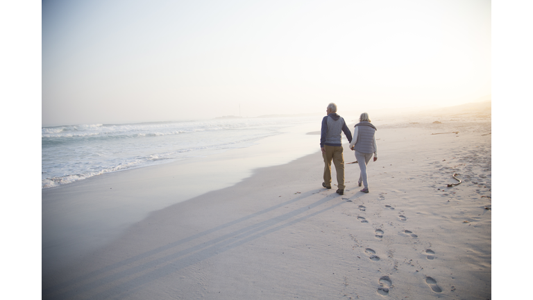 Senior couple walking on a beach together