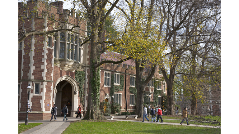 Students walking to classes near building in the Collegiate Gothic style, Princeton University, Princeton, NJ, USA