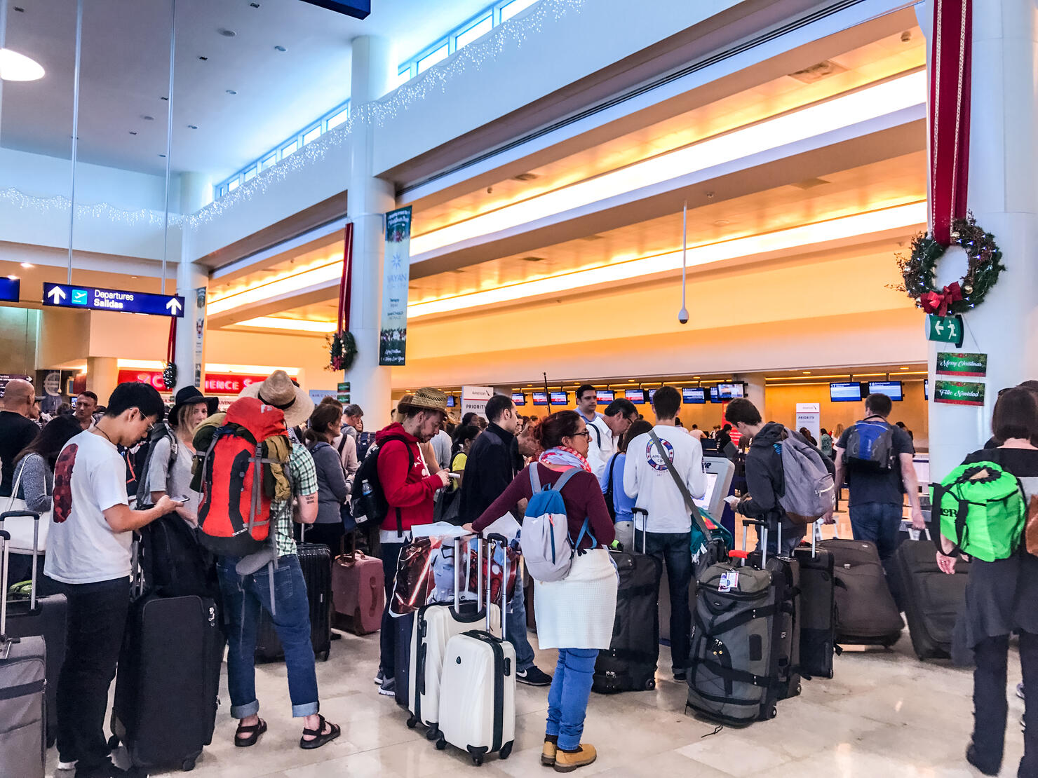 Crowds of passengers in departure area of Cancun International Airport, Mexico
