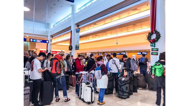 Crowds of passengers in departure area of Cancun International Airport, Mexico