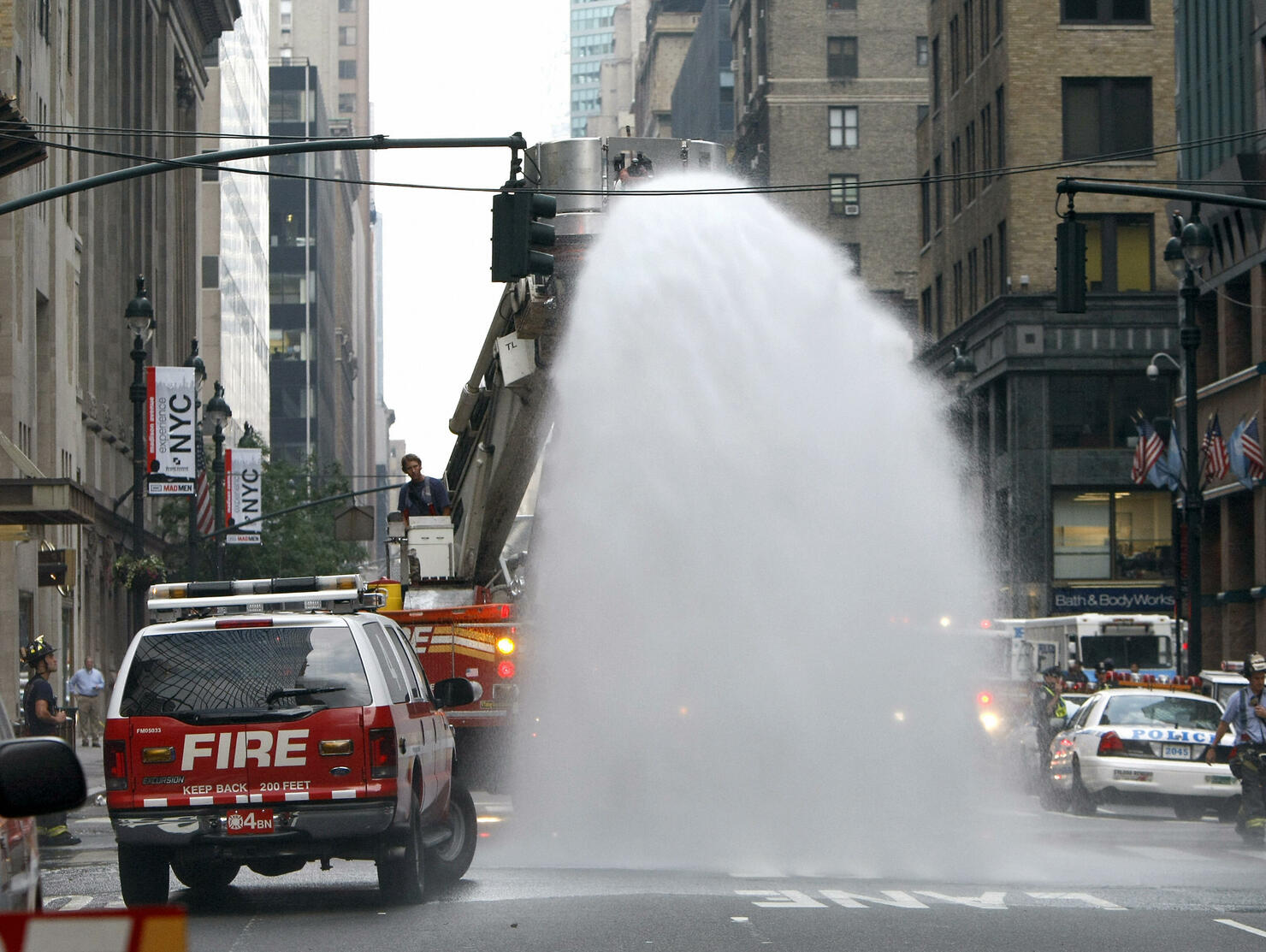 New York City firefighters hose debris a...