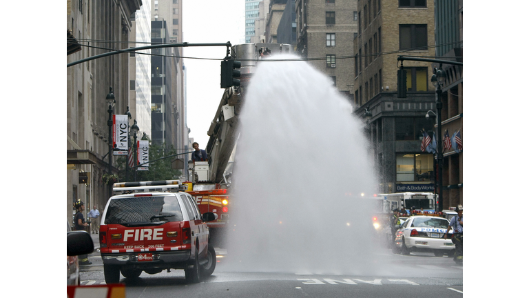 New York City firefighters hose debris a...