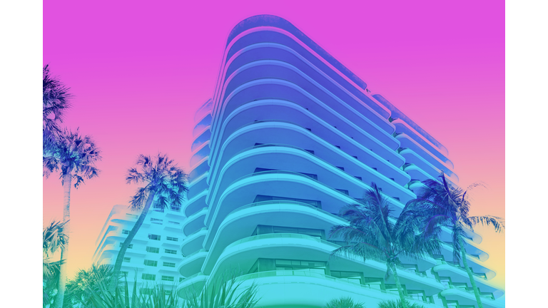 Dreamlike picture of colorful building with palm trees in Miami beach.