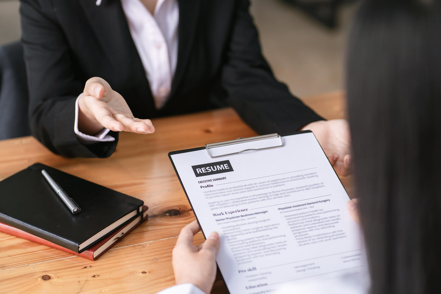 woman submit resume to employer to review job application. The concept presents the ability for the company to agree with the position of the job.