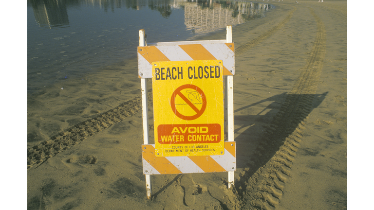 "A sign reading ?Avoid Water Contact? warning people that a beach at Marina del Rey, Los Angeles, CA, is closed due to pollution "