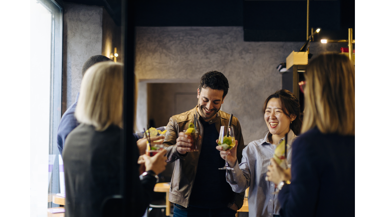 Colleagues celebrating after work in a bar