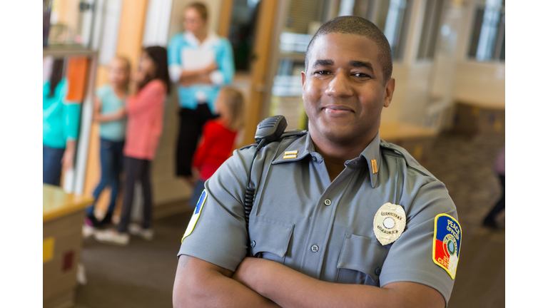 Friendly school security guard working on elementary school campus