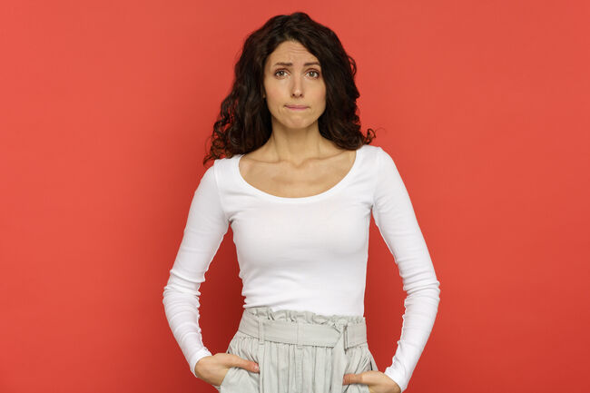 Portrait of grumpy unconfident young woman bite lips with tears in eyes, scared of mistake isolated