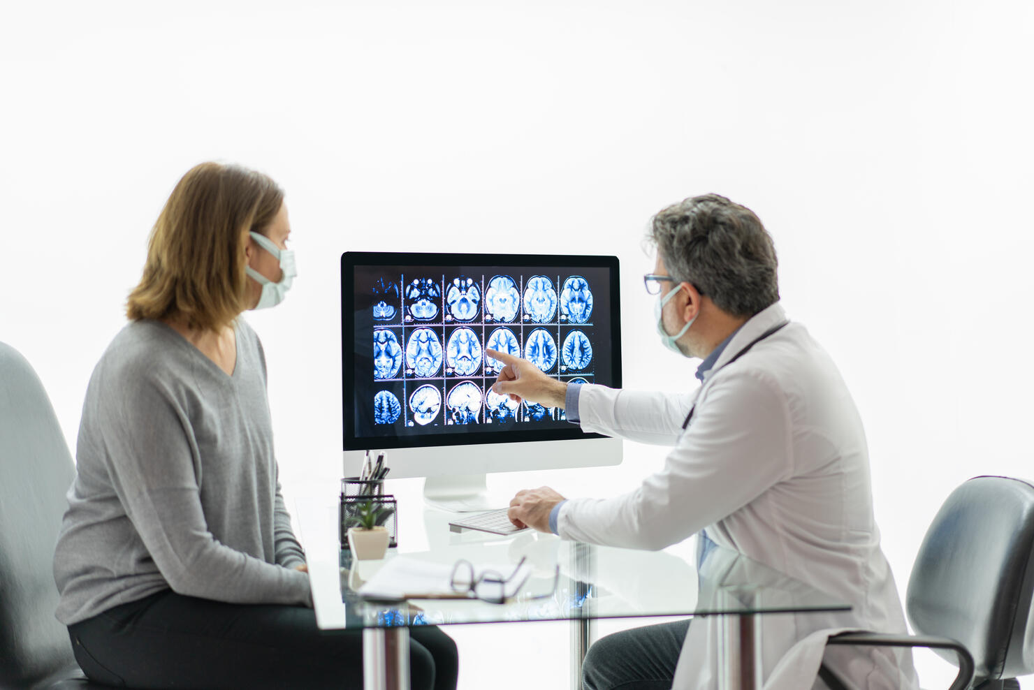 Female patient having consultation with neurologist in office