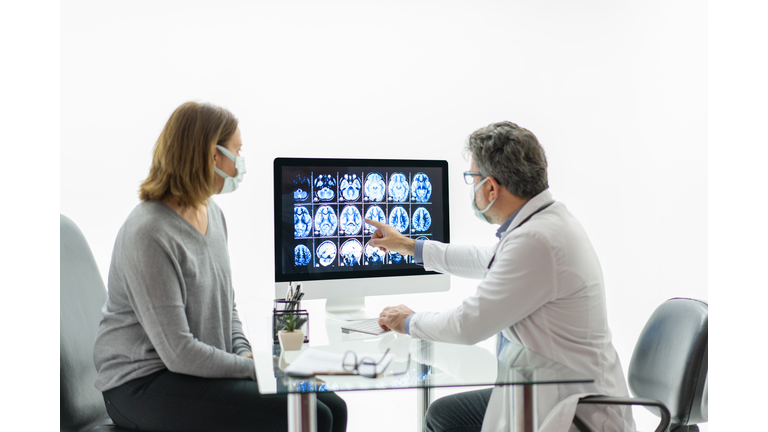 Female patient having consultation with neurologist in office