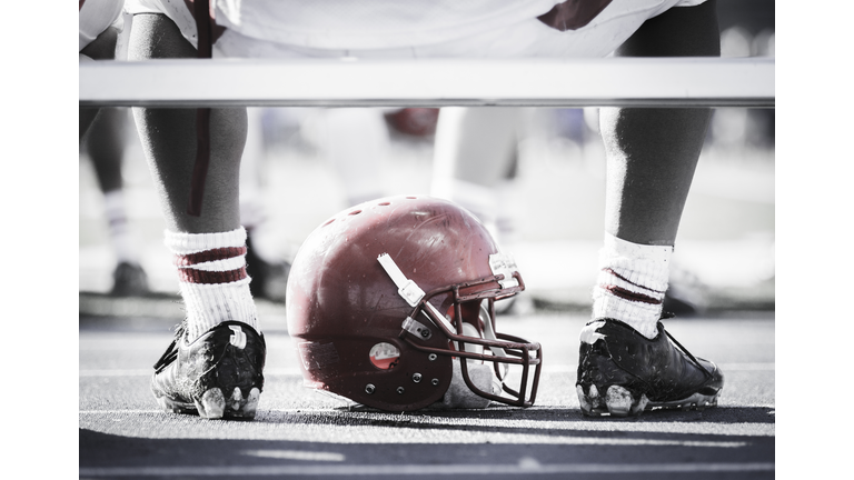 Football player on bench with helmet