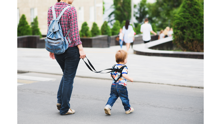 Mom insures her child during a walk