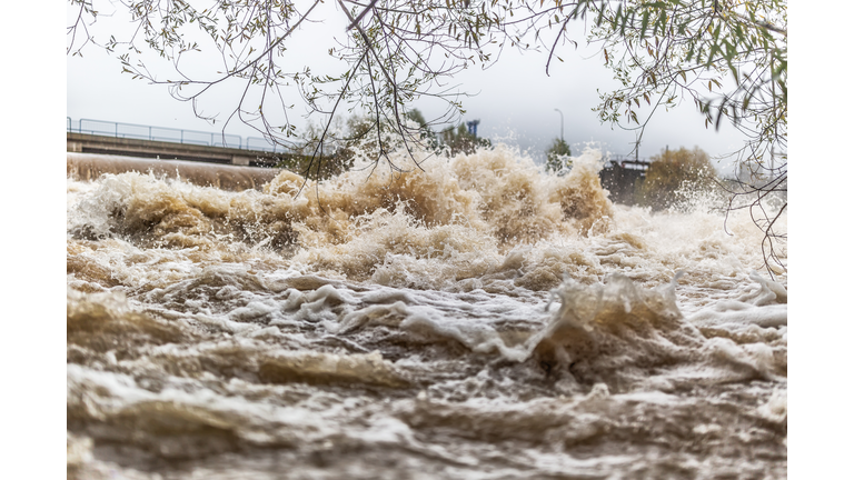 Flooded river during persistent heavy rain.