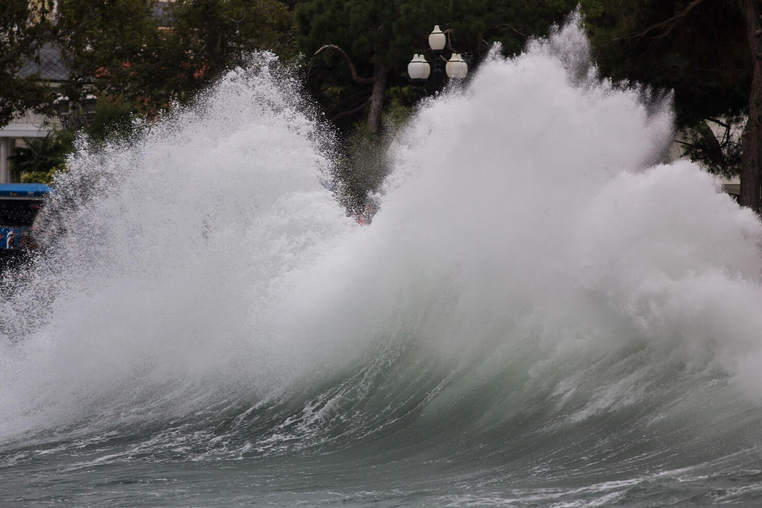 Storm wave breaking at northern coast in winter. Seasonal climate change with stormy sea and sky