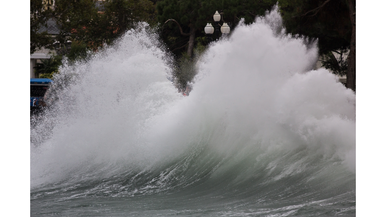 Storm wave breaking at northern coast in winter. Seasonal climate change with stormy sea and sky