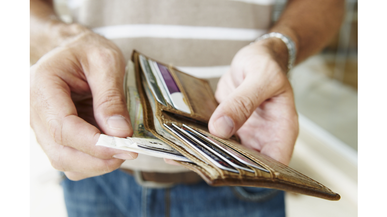 Man removes cash from wallet