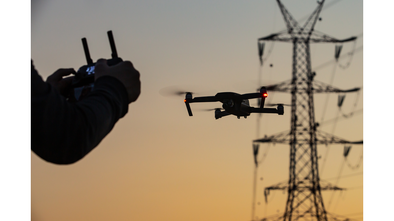 Low Angle View Of Person Photographing Against Sky During Sunset