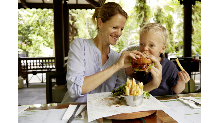 Mother with son (2-3) having lunch at terrace, Singapore
