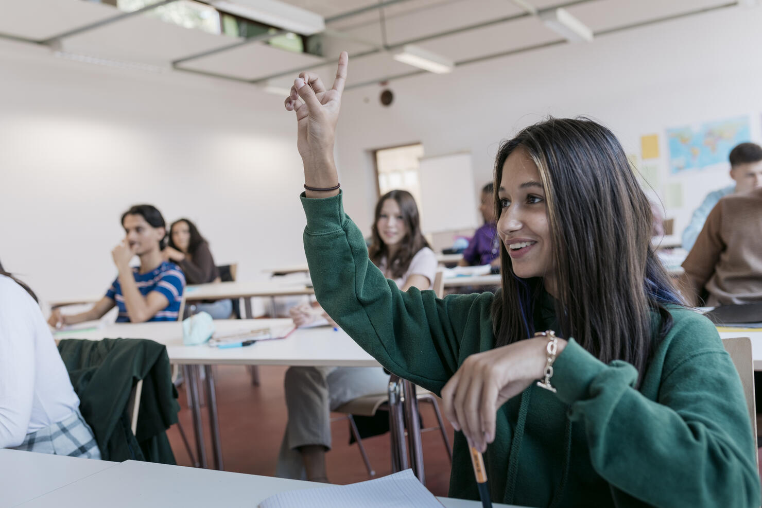 High School Student Raising Her Hand In Class