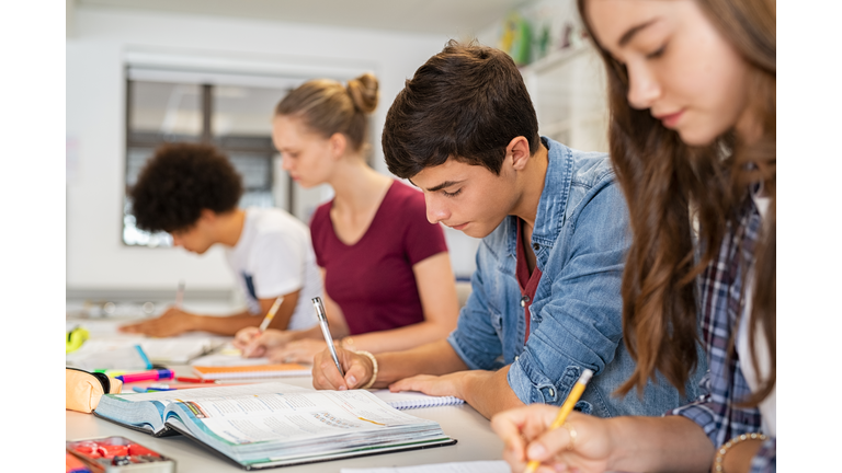 High school students doing exam in classroom