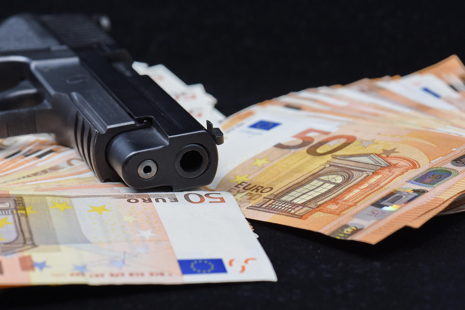 ull Frame Shot Of Fifty Euro Banknotes and a gun