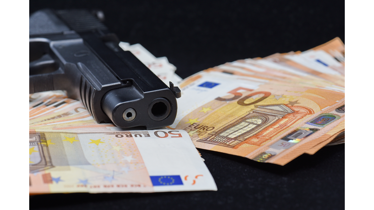 ull Frame Shot Of Fifty Euro Banknotes and a gun