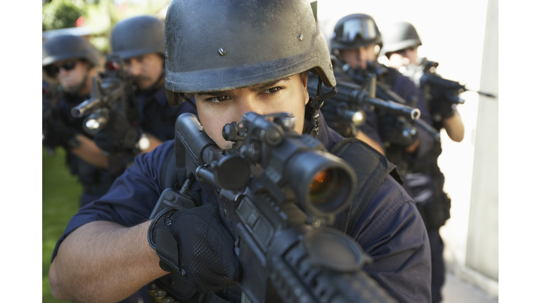Swat officers aiming guns