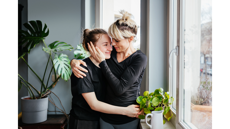 Single Mom Affectionately Hugging Teenage Daughter