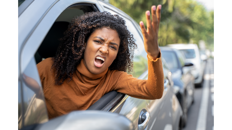 Rude black woman driver arguing and driving car