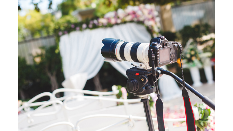 The work of photographer and videographer at the wedding. The camera and lens.