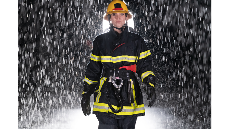 Portrait of a female firefighter standing and walking brave and optimistic.