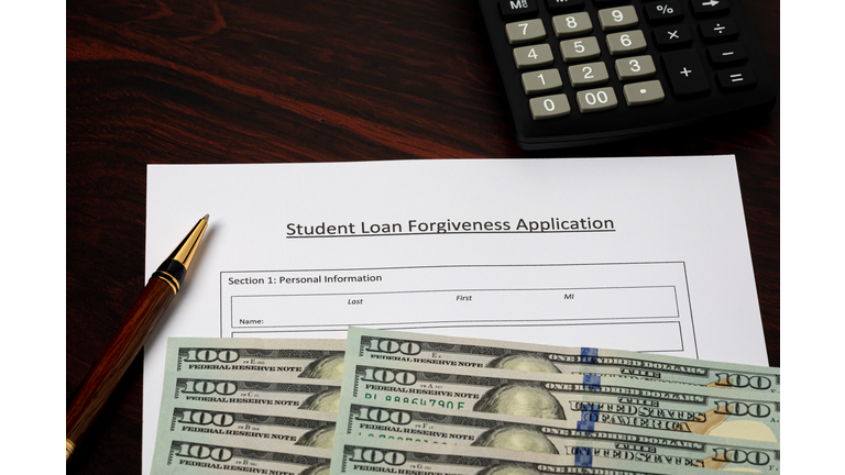 Student loan forgiveness application with cash money. Student debt crisis, tuition assistance and financial aid concept.